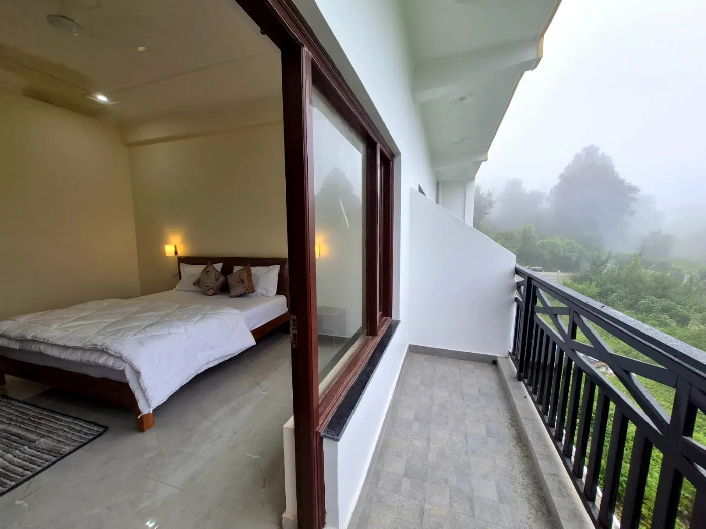Room with the balcony door open to the hills